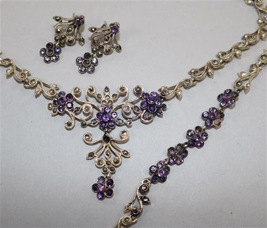 A silver, paste and marcasite demi parure, comprising a necklace, bracelet and pair or earrings.